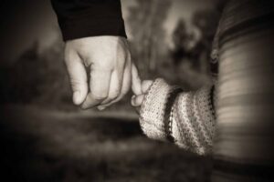 child holding parent's hand