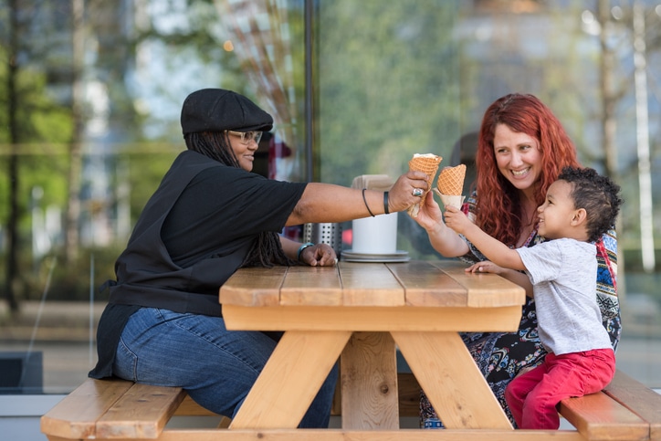 Birth and adoptive mother toasting kid