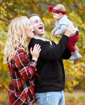 Adoptive couple admires their baby girl