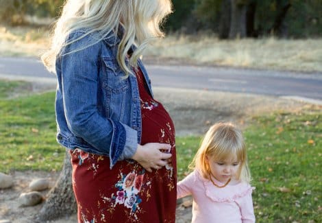 Pregnant woman with her toddler daughter