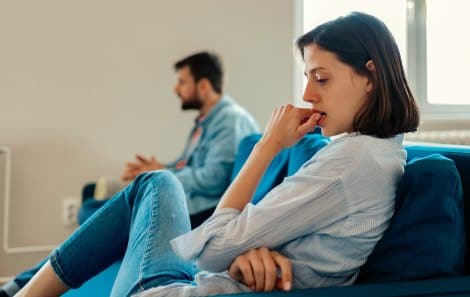 Married couple sit in silence after an argument 