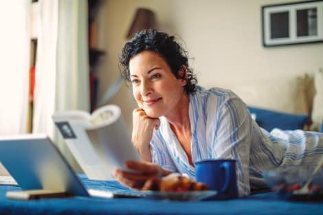 Woman reads Called to Adoption book in bed