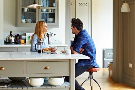 Married couple talking in their kitchen