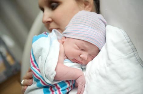 Birth mother spends a few moments with her baby at the hospital
