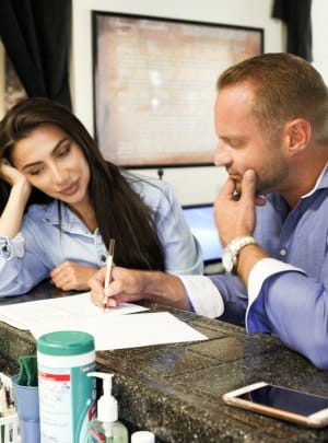 Couple completing adoption forms in their kitchen