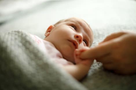 Newborn baby gazes into her mother's eyes