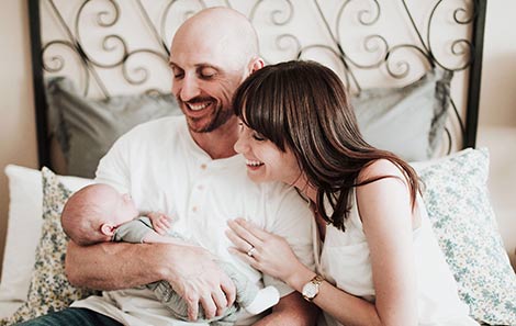 Nikolaus and Sarah admire their son, whom they adopted through Lifetime