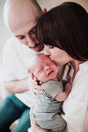 Adoptive parents Nikolaus and Sarah with their son