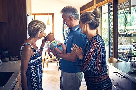 Family admires baby at adoption sip and see