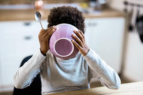 Some adopted children hoard food, like this little boy chowing down on cereal
