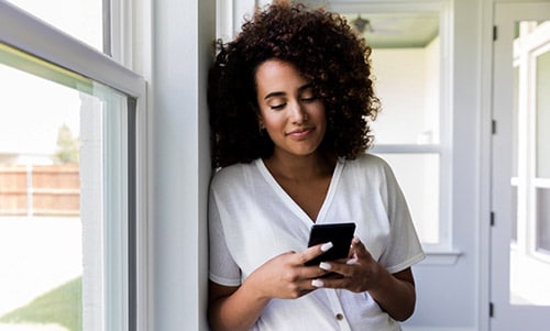 Young woman looking at adoption profiles online, thinking about what to ask Christian adoptive parents