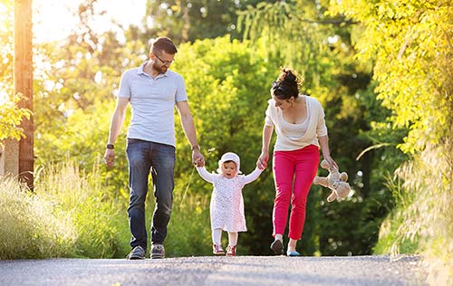 Happy young family having fun outside in spring nature