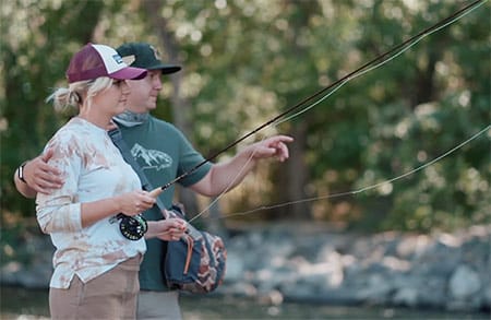 Andy helping Jeanna catch a fish