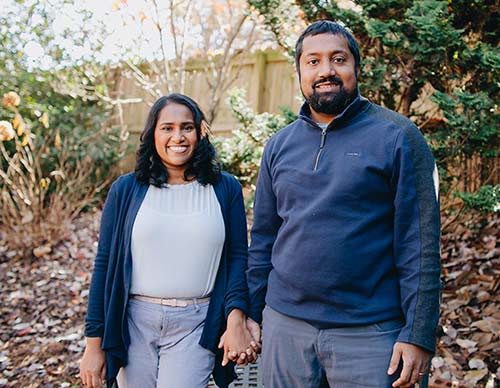 Hopeful adoptive parents Sara and Biju pause during a neighborhood stroll