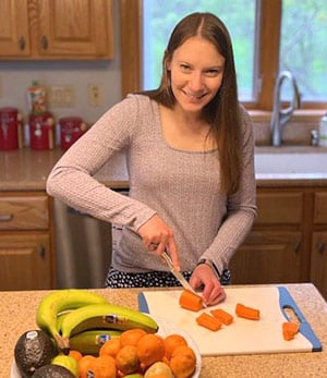 Kristen preparing something healthy and delicious in the kitchen