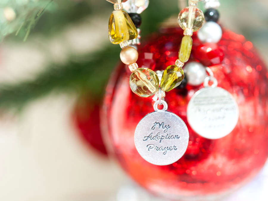 Adoption jewelry hanging on a Christmas tree