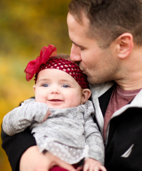 Adoptive father kisses daughter