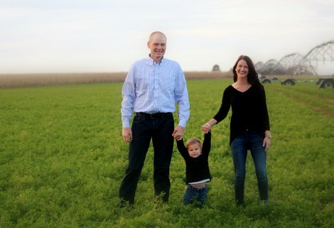 Christian adoptive parents Ross and Carol pose with their son Isaiah on their property