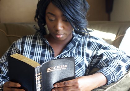 Pregnant Christian woman reading the BIble