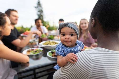 Adoptive mother holds her baby at an adoption sip and see