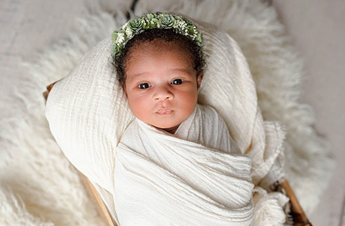 Adorable baby girl swaddled for a photo shoot