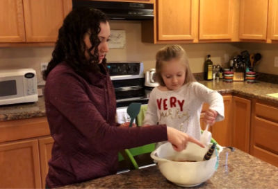 Sara and her daughter baking at Christmastime